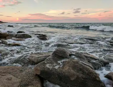 rocks and beach waves during sunset